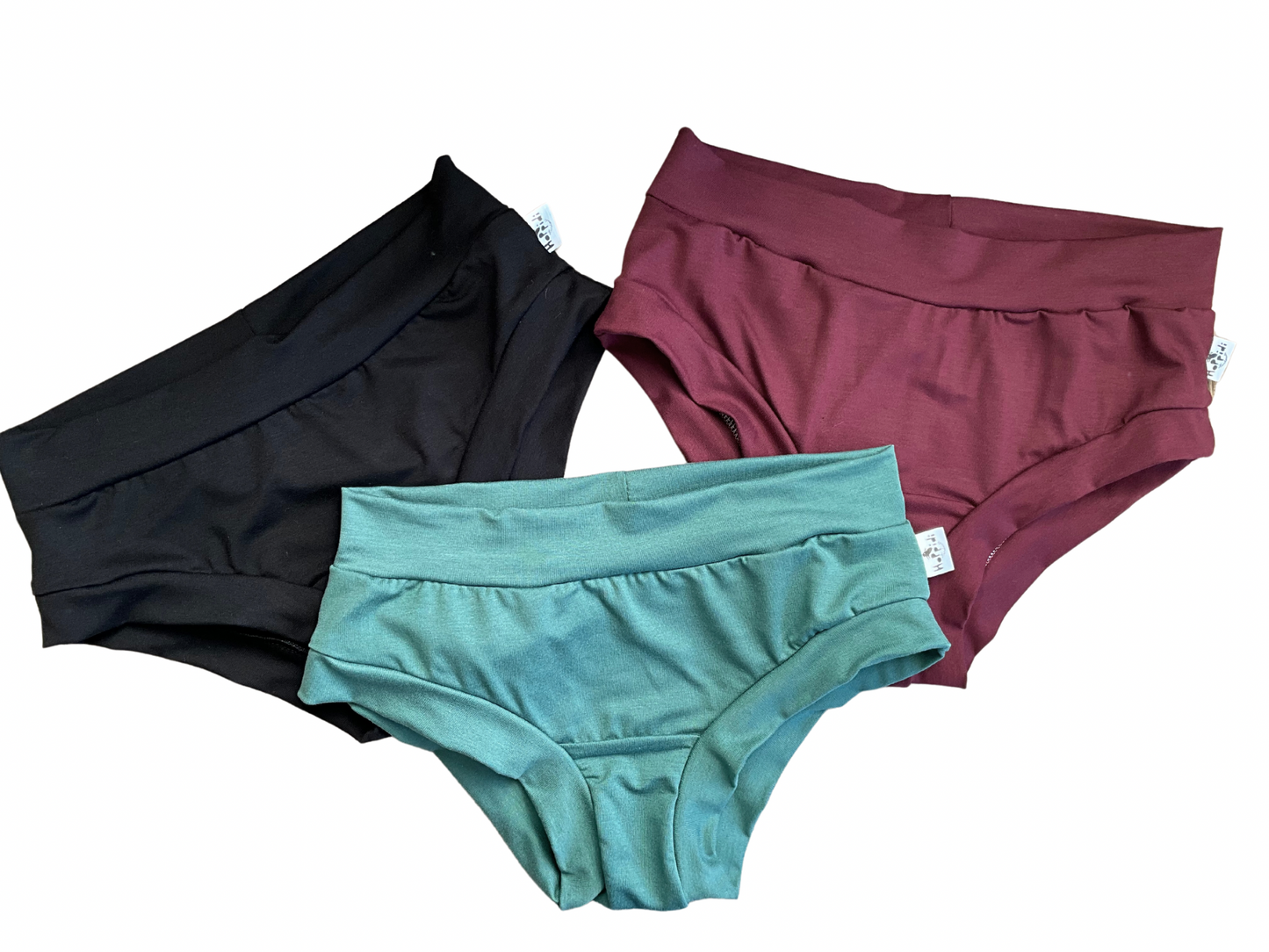 Black, red and green pairs of brief style underwear