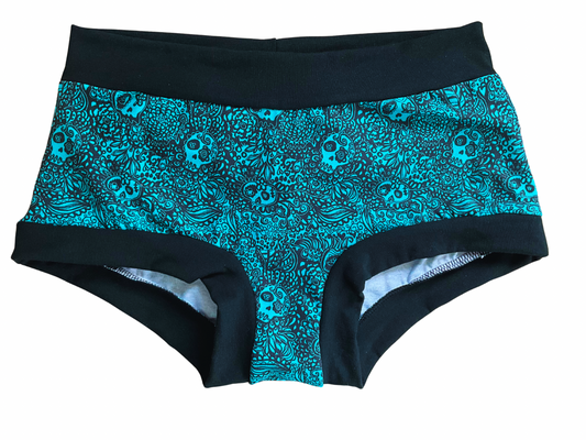 Boyshort style underwear with skulls print on turquoise background 