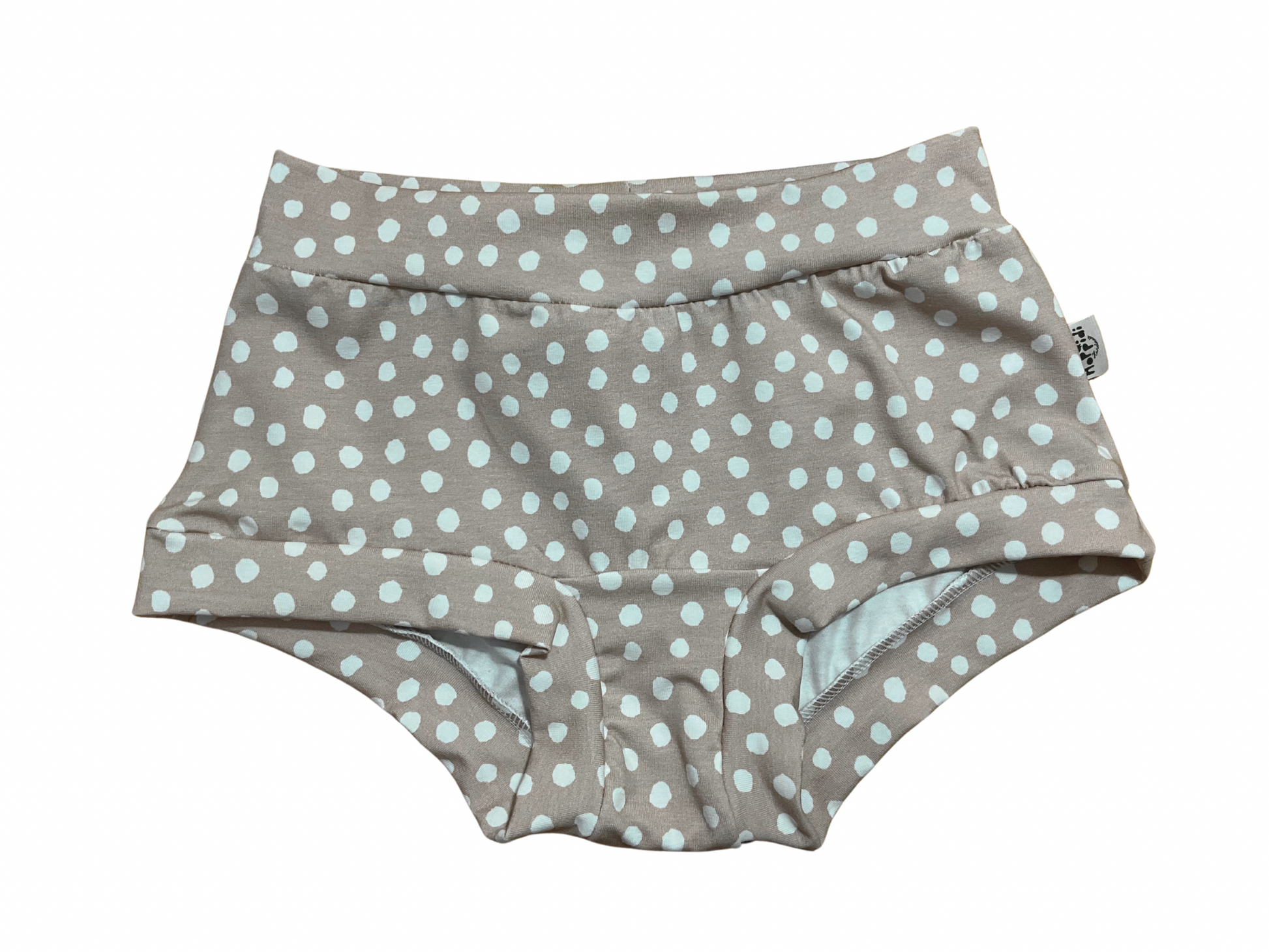 Boyleg style women’s underwear with polka dots pattern on beige background 