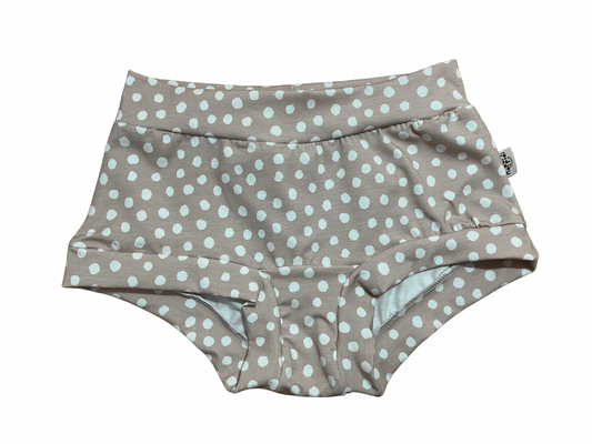 Boyleg style women’s underwear with polka dots pattern on beige background 