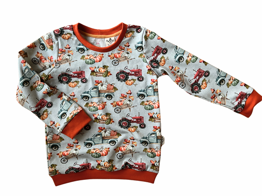 crew neck sweatshirt with pumpkin trucks and tractors.
