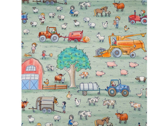 Fabric with farm scene on light green background. It shows pigs, cows, chicken, horses, geese and sheep, a red barn, farm equipment such as tractors and farm workers