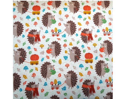 Hedgehogs in fall scene with leaves, pumpkins, mushrooms and apples. 