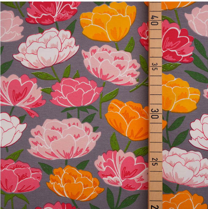 pink and yellow peonies on grey background